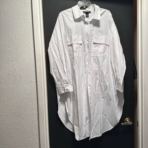 Ashley Stewart, white long button down pocket shirt. Slips on the side.